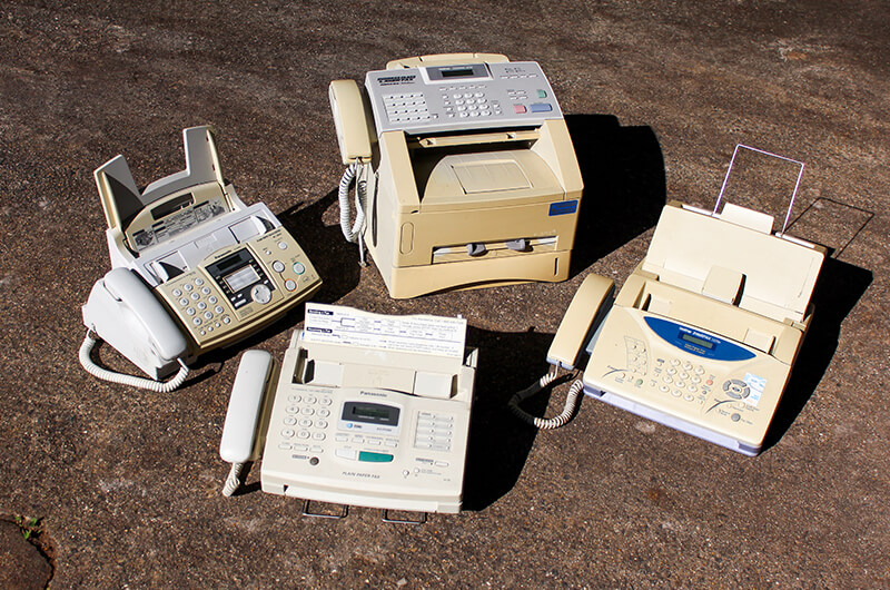 Four different fax machines on the ground