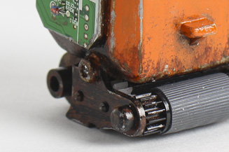 Close up of robot keychain made from fax parts bottom .